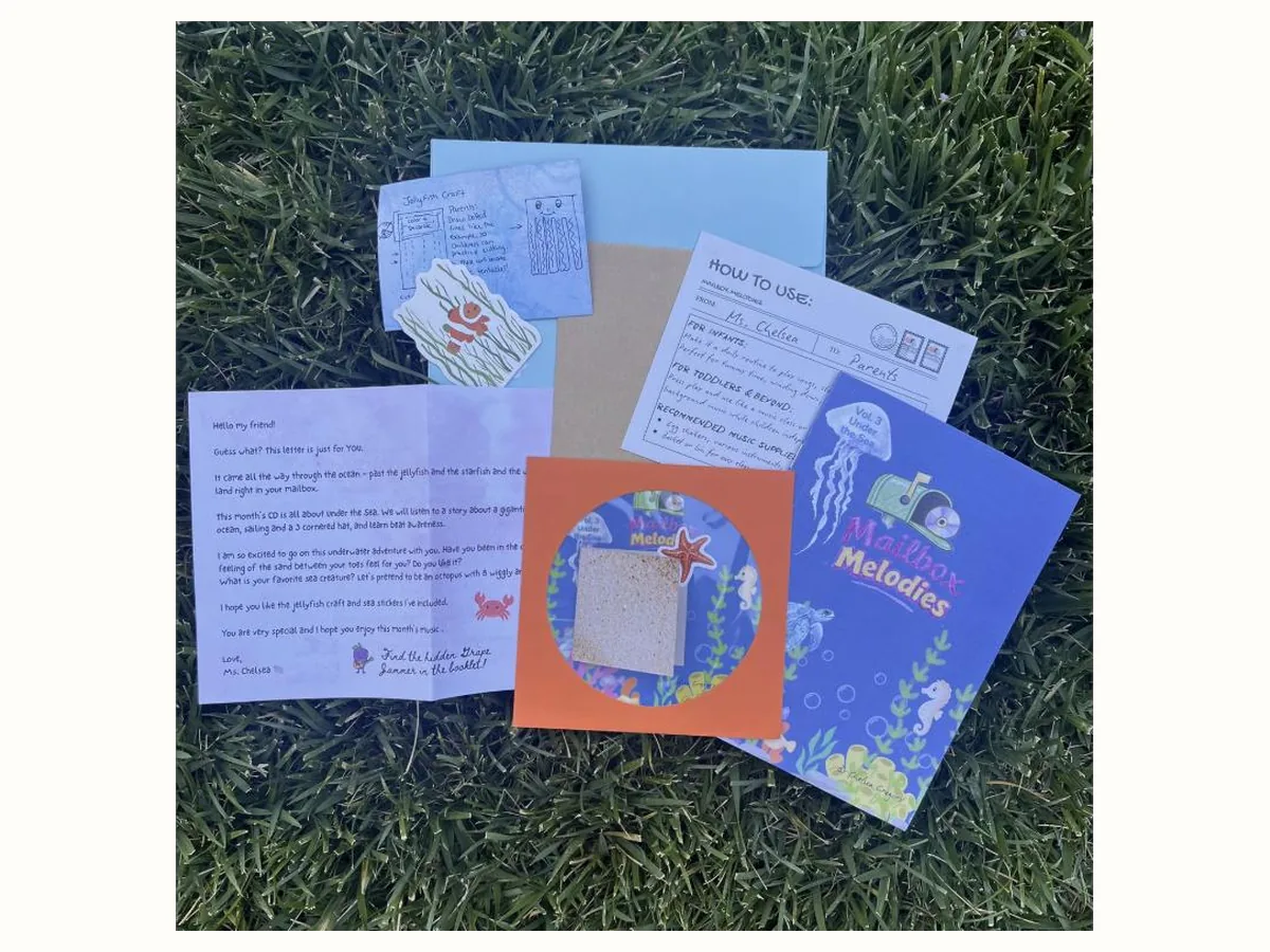 Everything from one Under the Sea volume laid out: letter from Ms. Chelsea, how-to-use card, jellyfish craft, stickers and the illustrated booklet