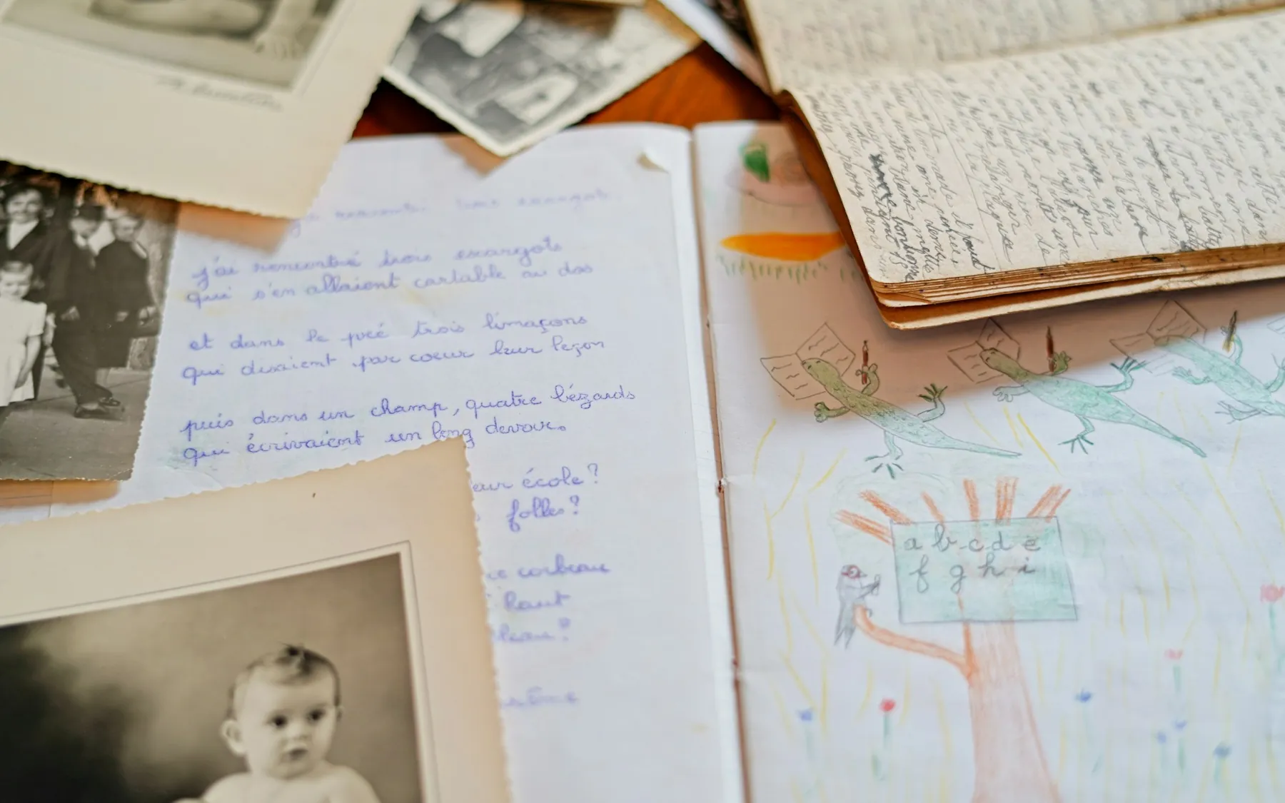 Letters, drawings and photographs spread across a table